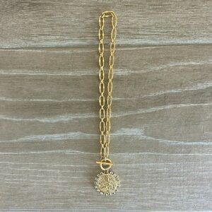 Pendant necklace surrounded by crystals. Front toggle clasp, lays beautifully!